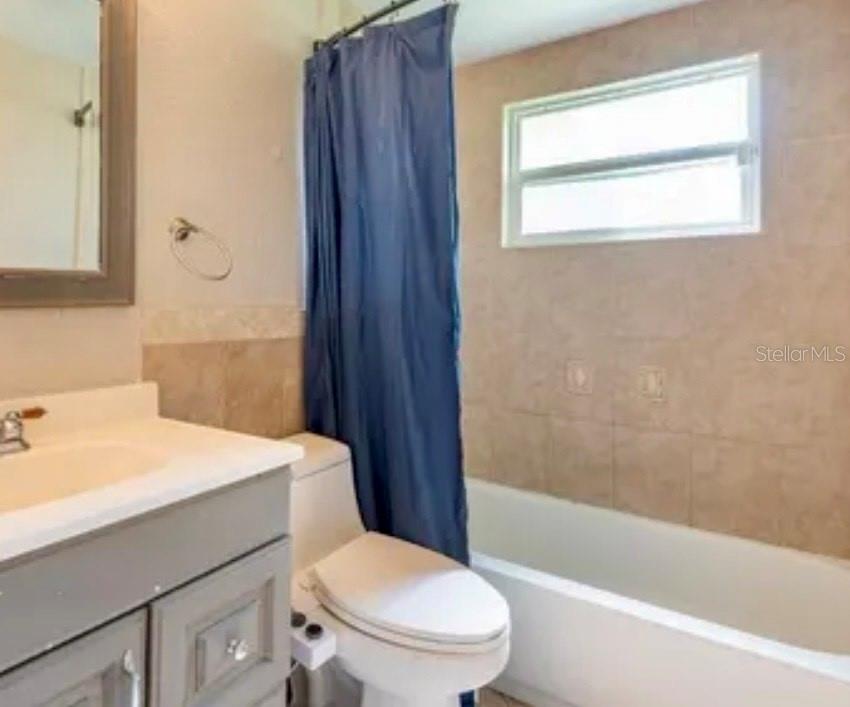 1602 Alert Street Holiday, FL 34690 - Photo 3 of 3 a bathroom with a sink a toilet and shower