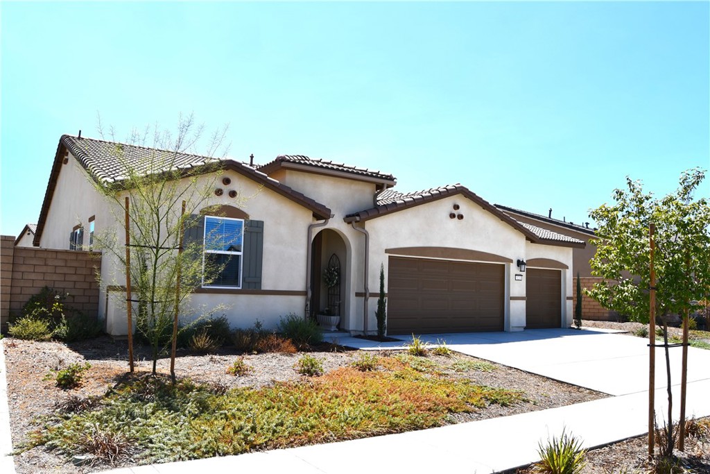 5233 Saloon Street Hemet, CA 92545 - Photo 28 of 28 a front view of a house with a yard and garage