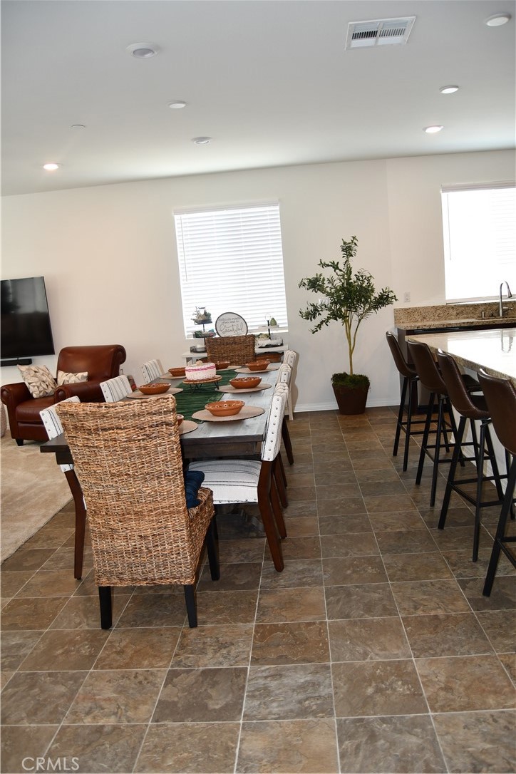 5233 Saloon Street Hemet, CA 92545 - Photo 3 of 28 a outdoor dining space with furniture and a potted plant
