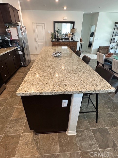 5233 Saloon Street Hemet, CA 92545 - Photo 9 of 28 a view of kitchen island with granite countertop sink and living room