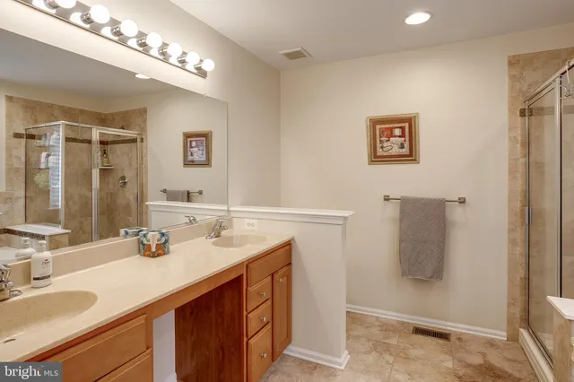 a bathroom with a sink double vanity and shower