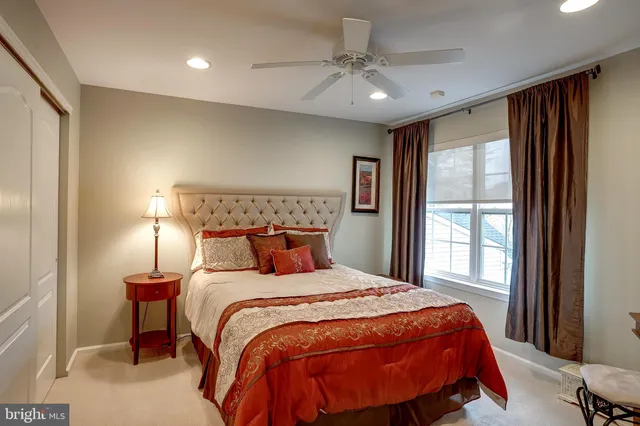 a bedroom with a large bed and a window