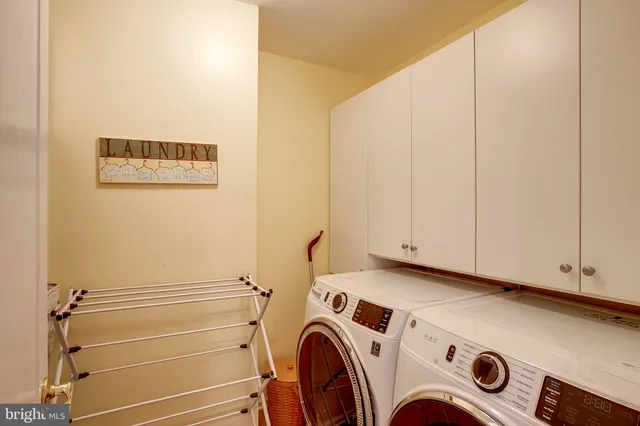 a view of bathroom with washer and dryer