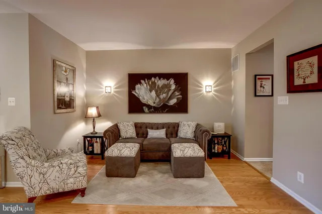 a living room with furniture and wall paintings