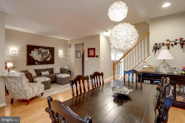 a living room with furniture chandelier and a table