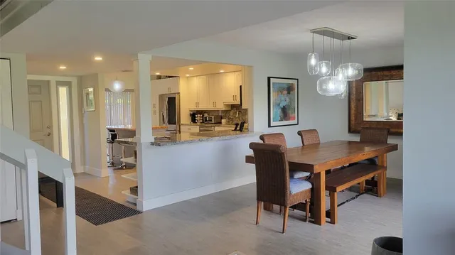 a room with dining table and chairs