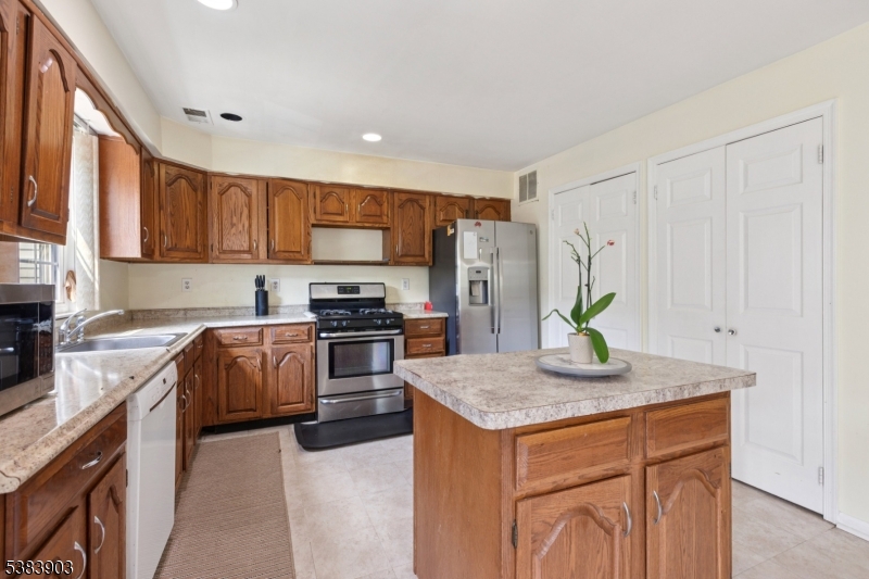 3606 Springbrook Drive Edison, NJ 08820 - Photo 14 of 25 a kitchen with stainless steel appliances granite countertop a stove a sink a refrigerator a counter space and refrigerator