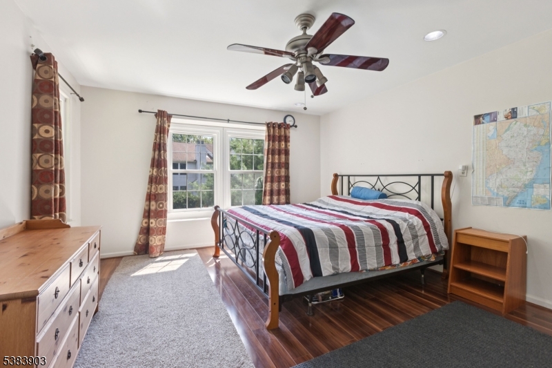 3606 Springbrook Drive Edison, NJ 08820 - Photo 17 of 25 a spacious bedroom with a bed and a chandelier