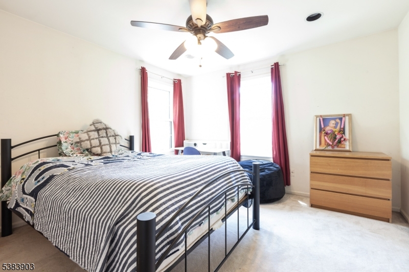 3606 Springbrook Drive Edison, NJ 08820 - Photo 20 of 25 a bedroom with a bed and a chandelier
