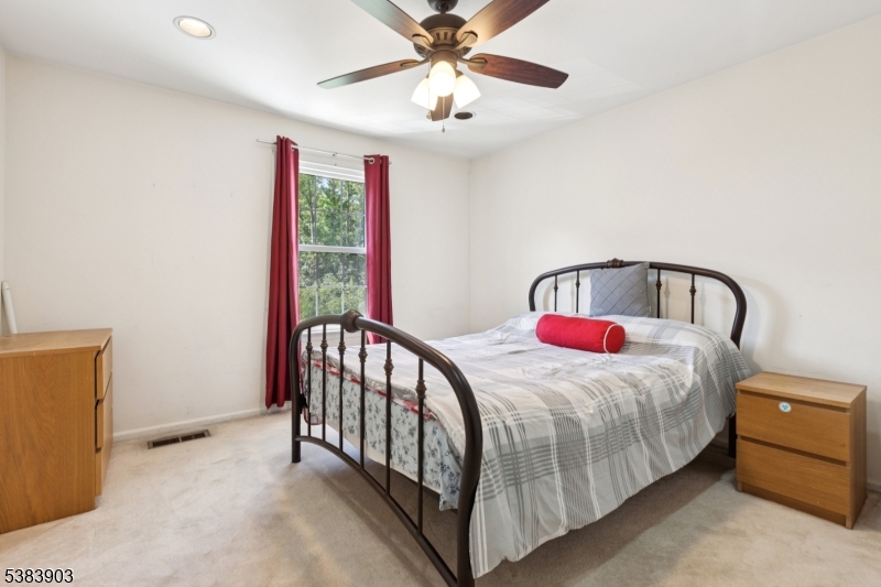 3606 Springbrook Drive Edison, NJ 08820 - Photo 22 of 25 a bedroom with a bed and a chandelier