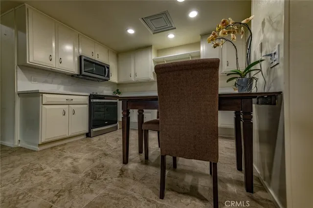 a kitchen with stainless steel appliances granite countertop a refrigerator and microwave