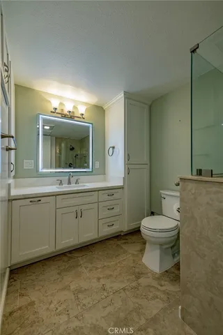 a spacious bathroom with a toilet sink and mirror