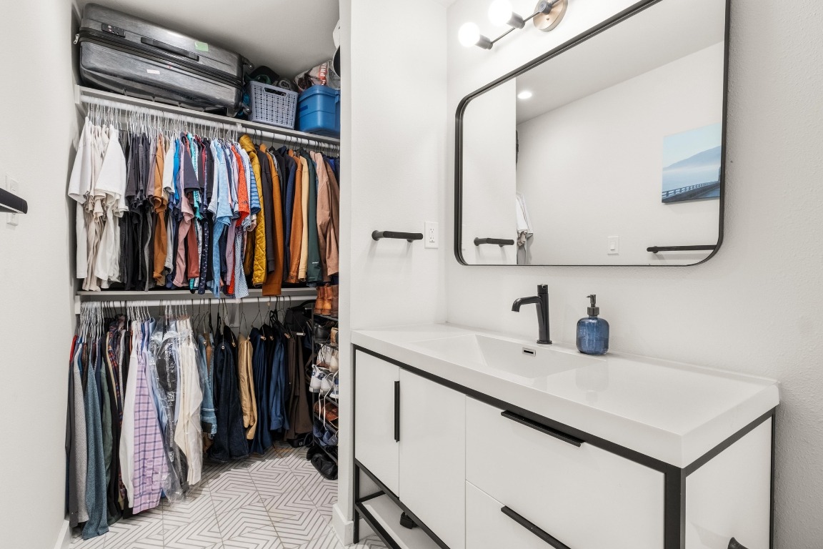 1213 Hollow Creek Drive, Unit 3 Austin, TX 78704 - Photo 12 of 15 a view of walk in closet with clothes and shoes