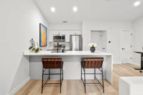 a kitchen with stainless steel appliances a sink and cabinets