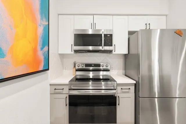 a kitchen with a stove and a microwave