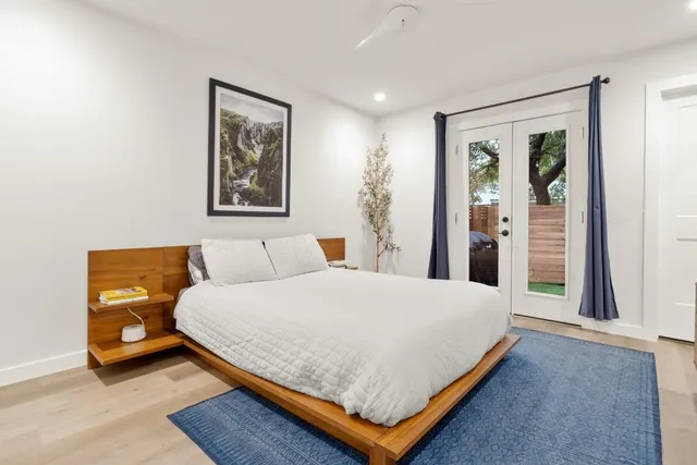 a bedroom with a bed and a large window