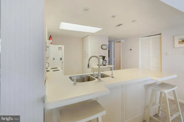 a kitchen with a sink and a refrigerator