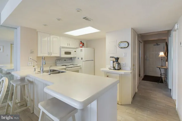 a kitchen with refrigerator cabinets and wooden floor