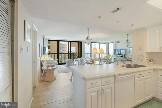 a kitchen with sink and white cabinets