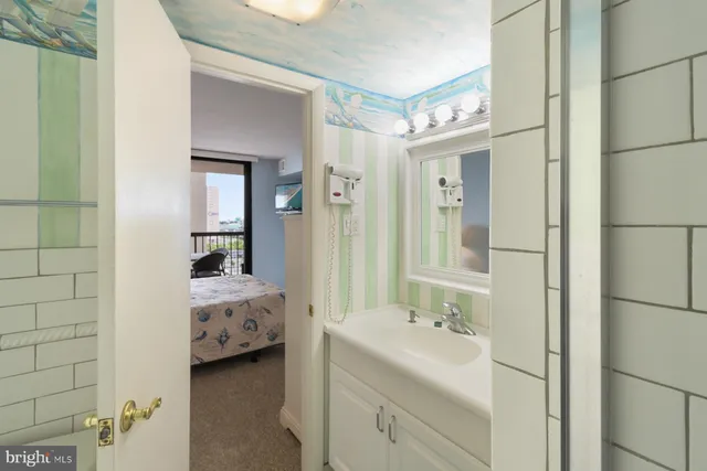 a en suite bathroom with a double vanity sink a mirror and a shower