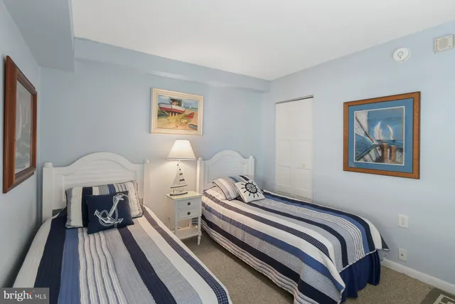 a bed room with bed and a painting on the wall