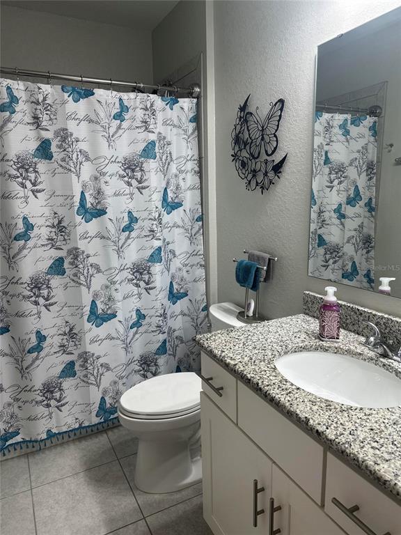 2137 Apian Way Port Charlotte, FL 33953 - Photo 20 of 25 a bathroom with a granite countertop sink a toilet and a mirror