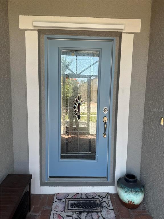 2137 Apian Way Port Charlotte, FL 33953 - Photo 3 of 25 a room with a wooden floor and a potted plant