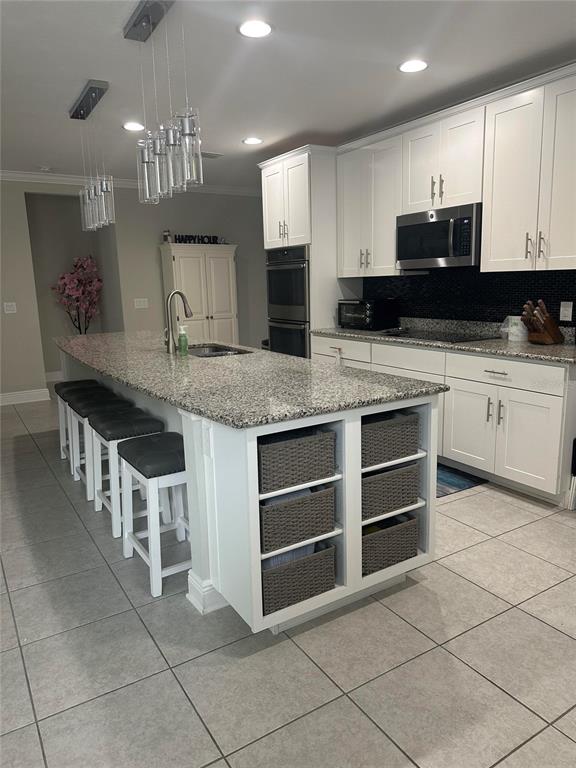 2137 Apian Way Port Charlotte, FL 33953 - Photo 10 of 25 a kitchen with stainless steel appliances granite countertop a stove and a sink