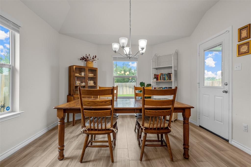 10712 Peperak Court Waco, TX 76708 - Photo 12 of 25 a view of a dining room with furniture and a chandelier