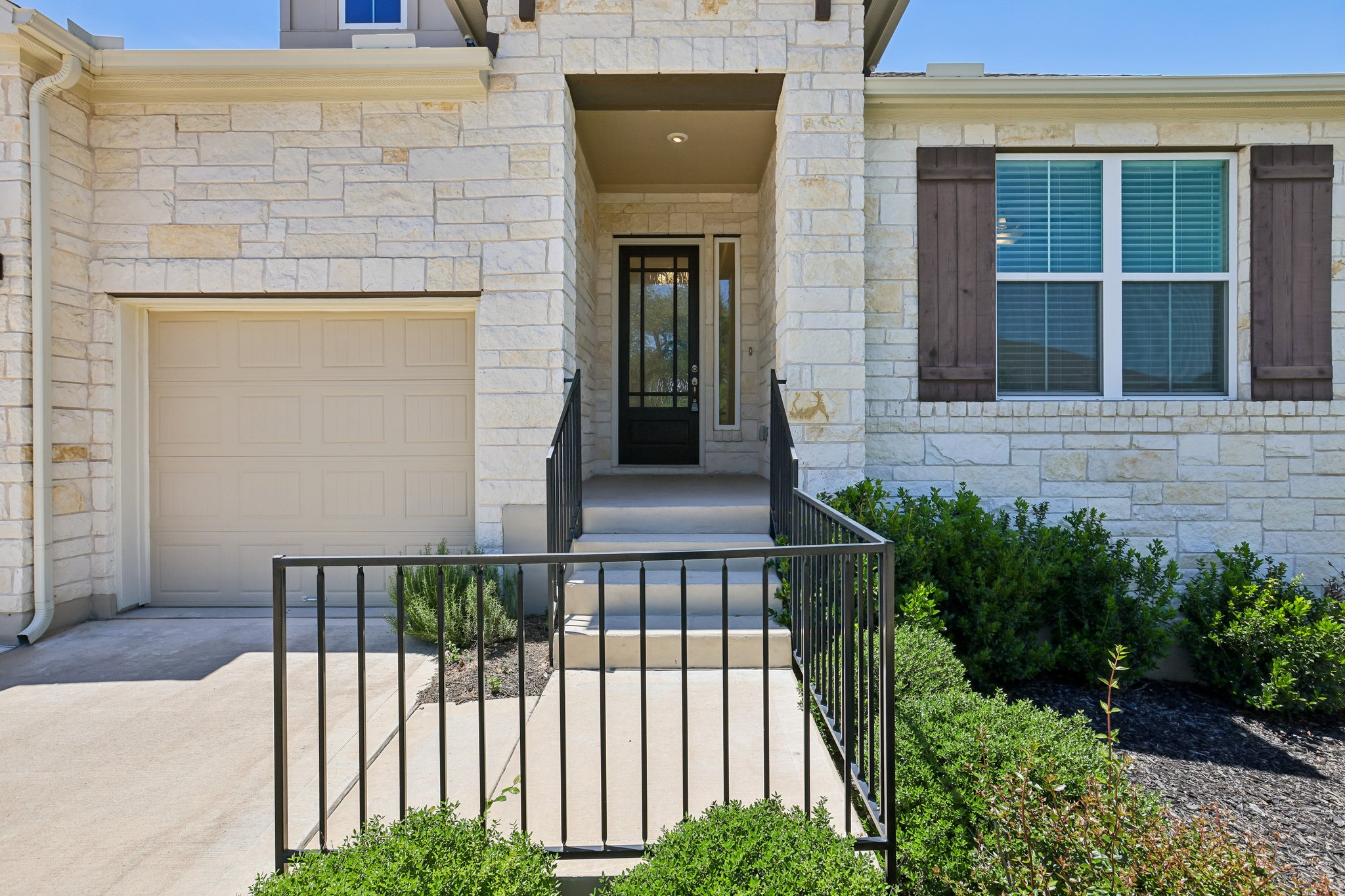 317 Independence Drive Kyle, TX 78640 - Photo 4 of 40 a view of a house with large windows and plants
