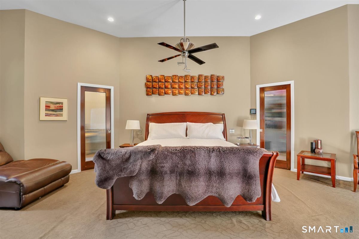 122 Ridgeview Circle Guilford, CT 06437 - Photo 10 of 40 Master suite with carpet, recessed lights, ceiling fan, two large walk-in closets/dressing rooms (shelving conveys), updated bath, and access to deck.