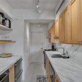 a kitchen with a sink a stove and cabinets