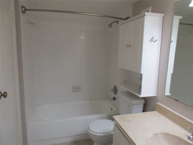 a bathroom with a shower and a toilet