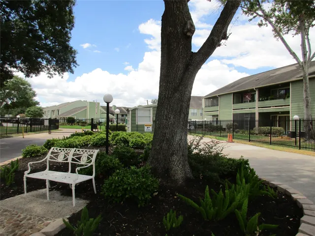 a view of a patio with table and chairs and potted plants