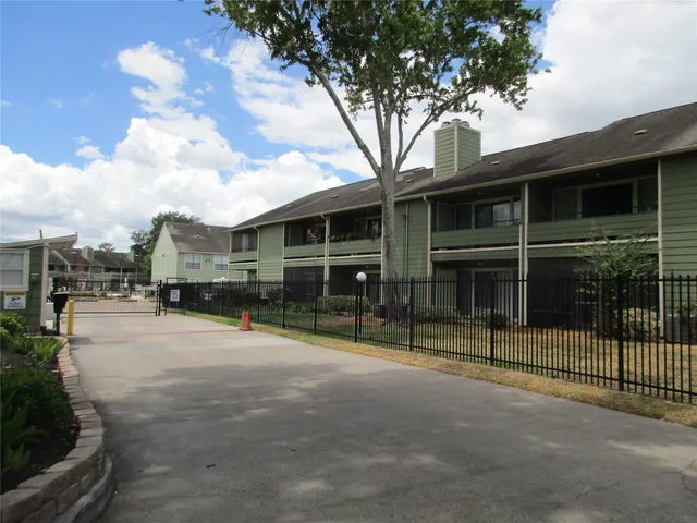 a view of a house with a backyard and a tree