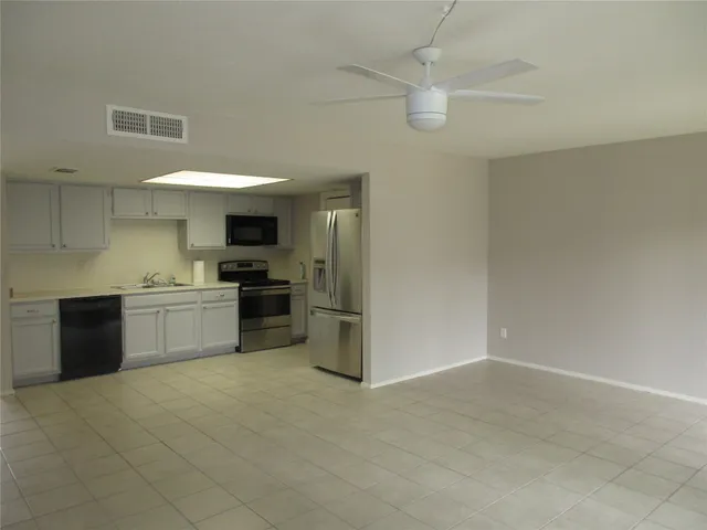 a kitchen with a sink stainless steel appliances and cabinets