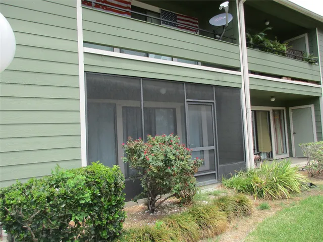 a view of house with door and wooden bench