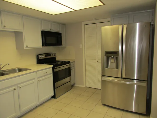 a kitchen with a refrigerator and a sink