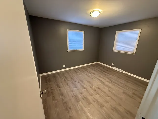 a view of room with window and hardwood floor