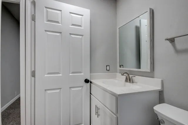 a view of a house with a backyard and trees