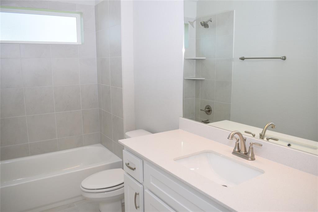 2605 Sam Bass Road, Unit 25 Round Rock, TX 78681 - Photo 14 of 25 a bathroom with a sink a toilet and shower