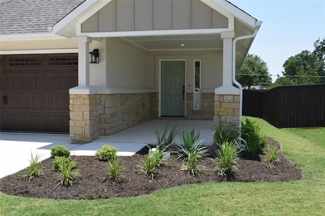 a front view of a house with garden