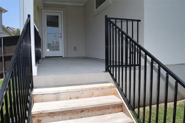 a view of balcony with wooden fence