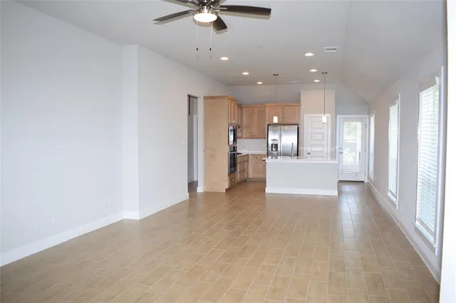 a view of a kitchen with a sink and a refrigerator