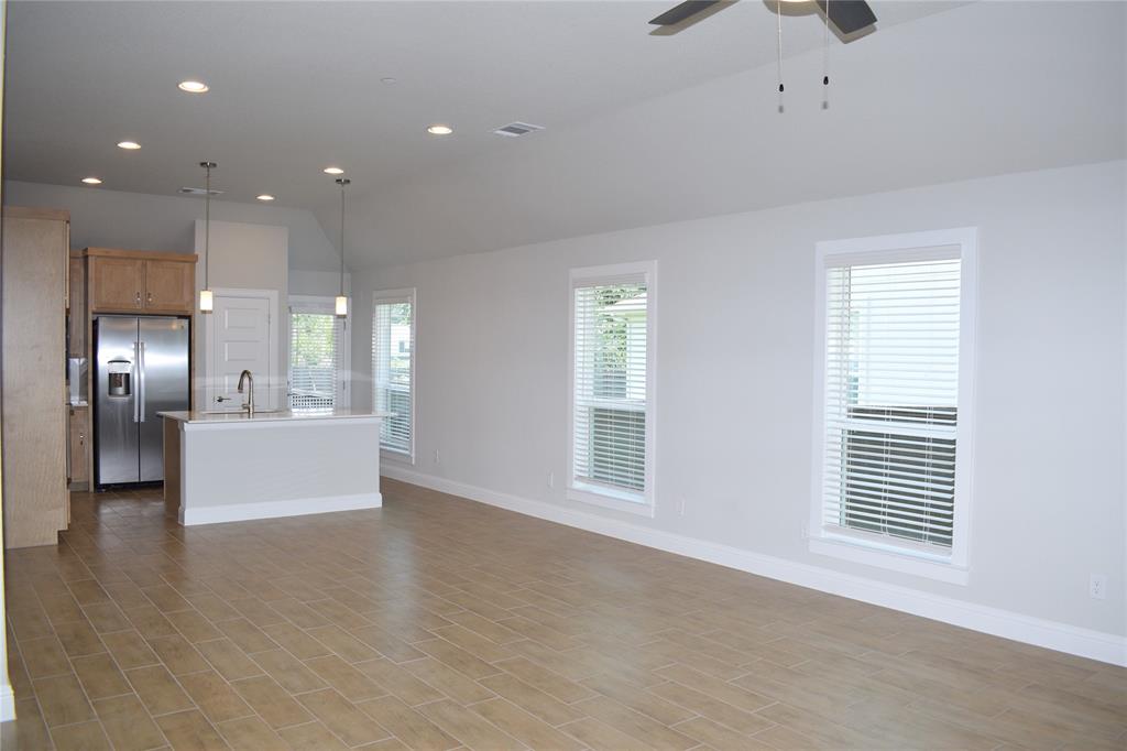 2605 Sam Bass Road, Unit 25 Round Rock, TX 78681 - Photo 5 of 25 a view of an empty room with kitchen and window
