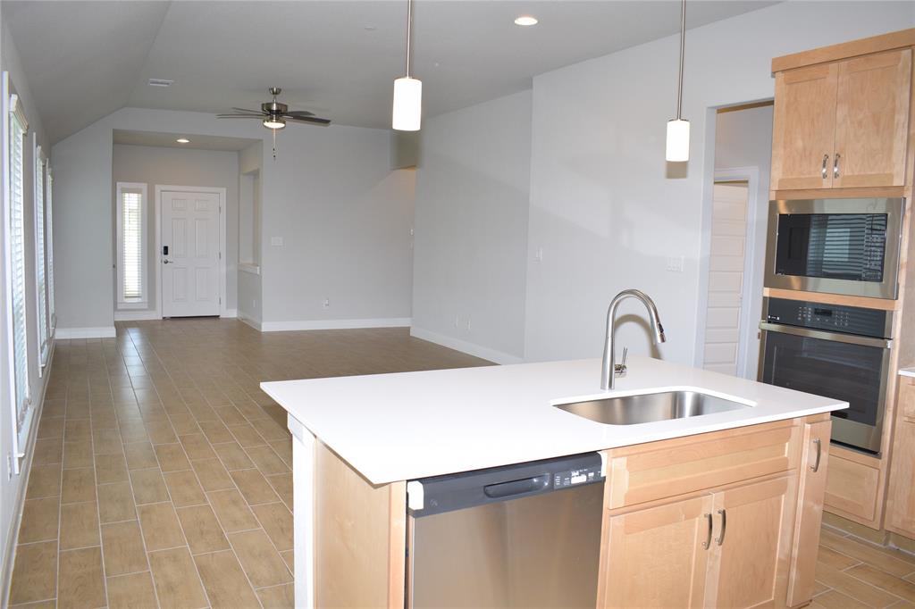 2605 Sam Bass Road, Unit 25 Round Rock, TX 78681 - Photo 25 of 25 a kitchen with stainless steel appliances a sink a microwave a stove and white cabinets