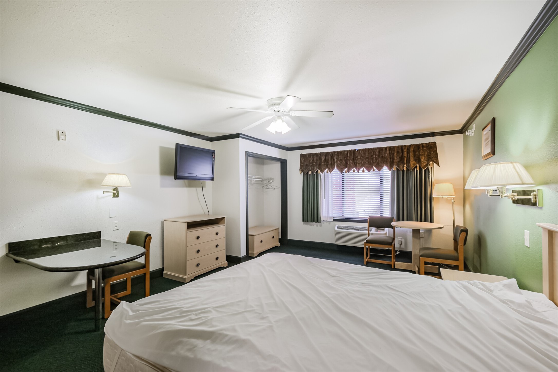 1025 Swanson Street, Unit 211 Houston, TX 77030 - Photo 12 of 18 a bedroom with a bed and a chandelier