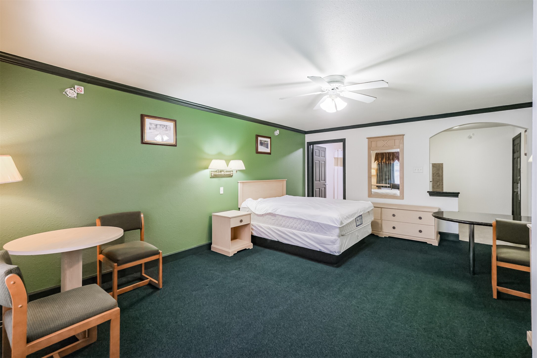 1025 Swanson Street, Unit 211 Houston, TX 77030 - Photo 13 of 18 a bedroom with a bed and a chandelier