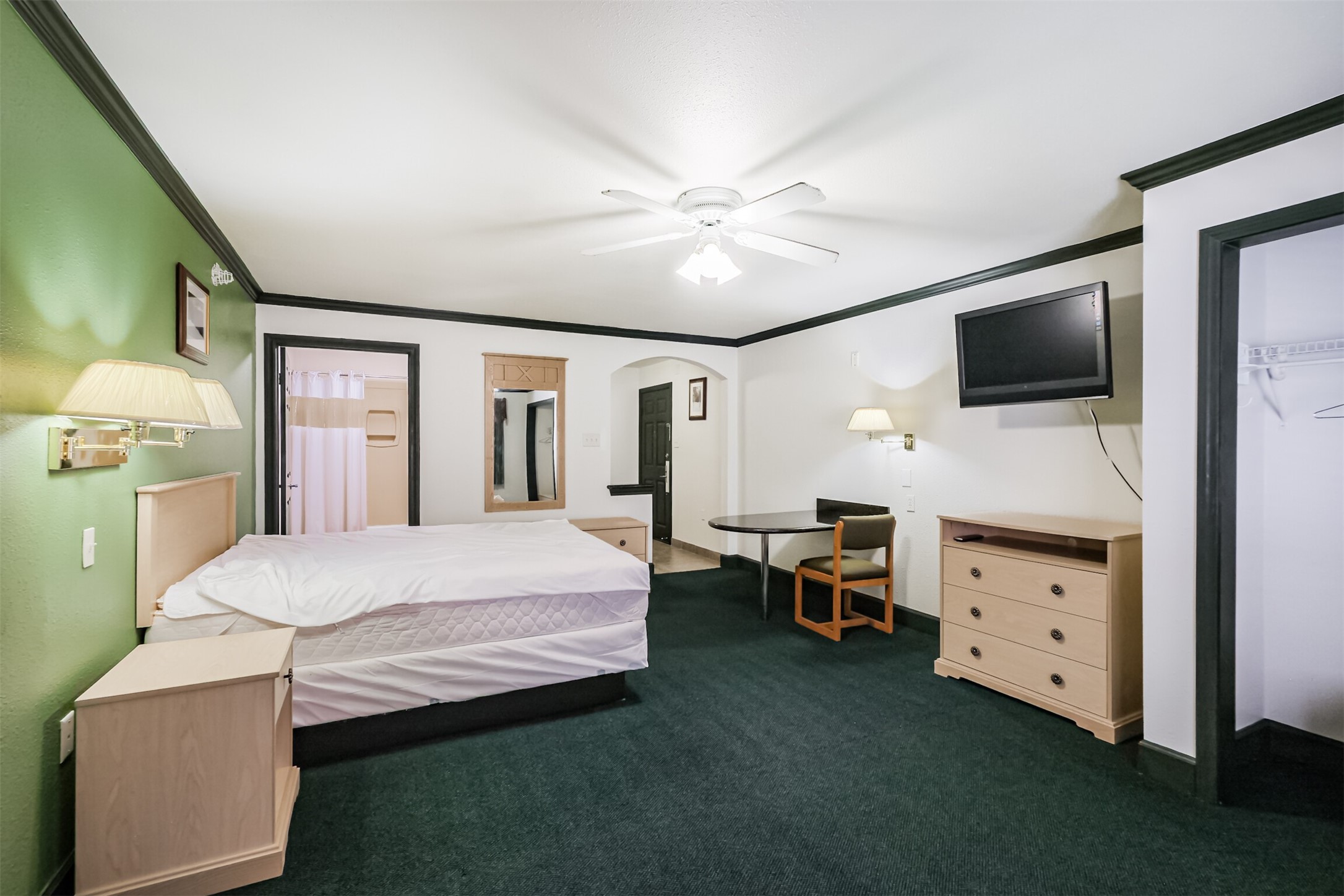 1025 Swanson Street, Unit 211 Houston, TX 77030 - Photo 14 of 18 a bedroom with a bed and a flat tv screen on dresser