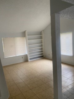 a view of an empty room and a window